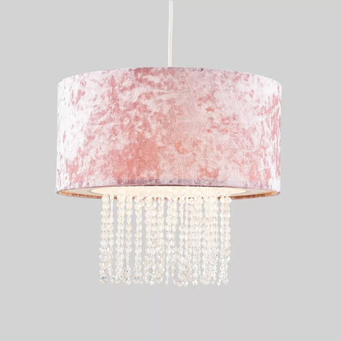 Gold velvet pendant light illuminating a dining area

