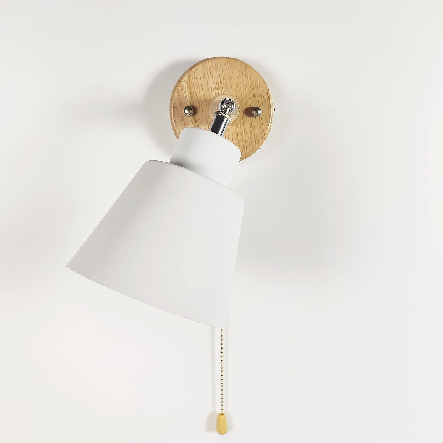 Wall-mounted bedside lamp with a pull cord switch for convenience
