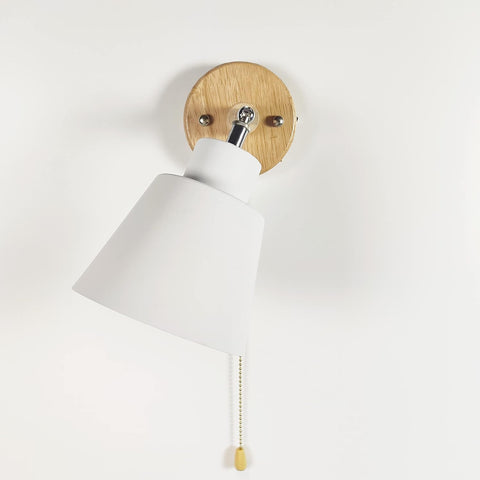 Wall-mounted bedside lamp with a pull cord switch for convenience
