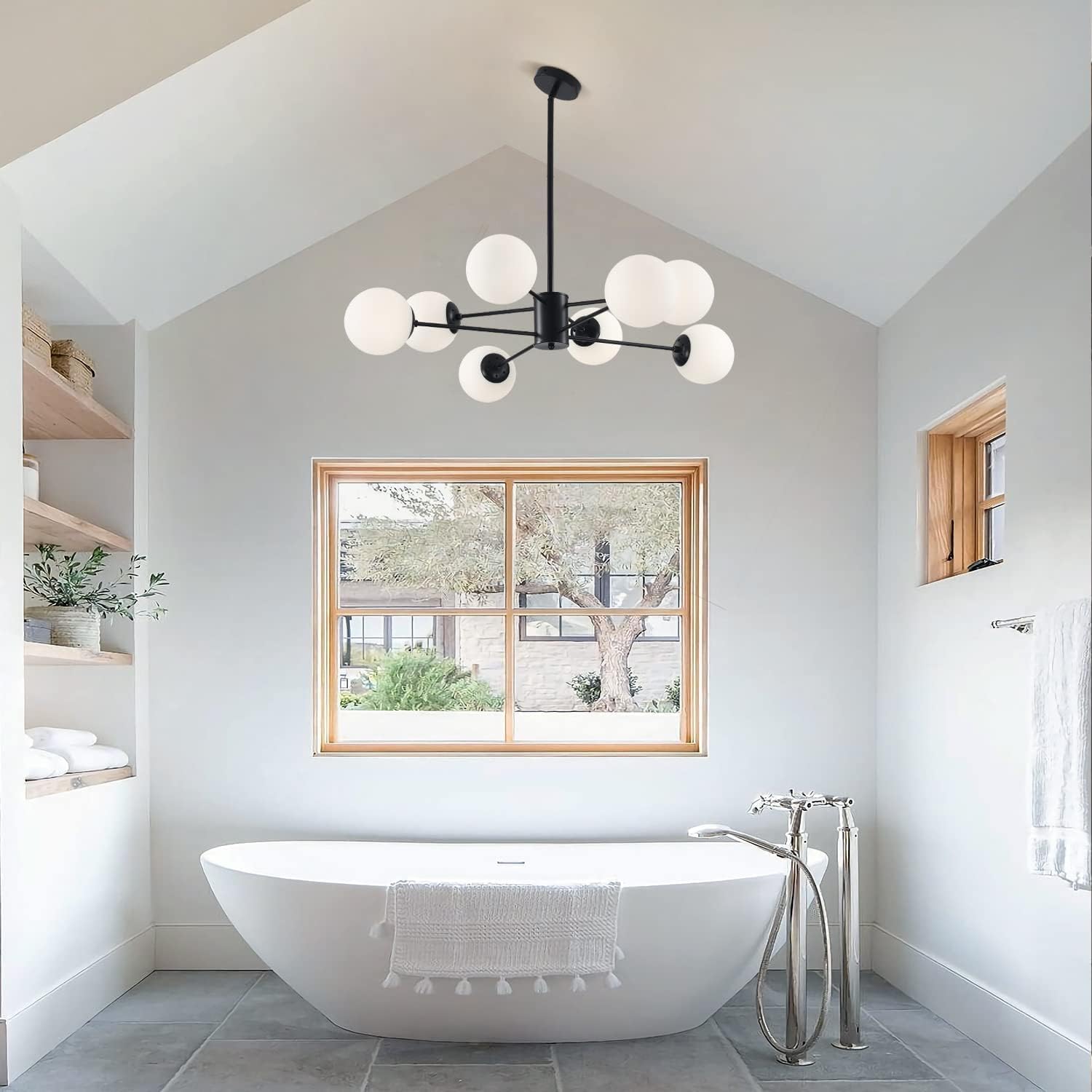 Modern bathroom with a freestanding bathtub, chandelier, and framed window.