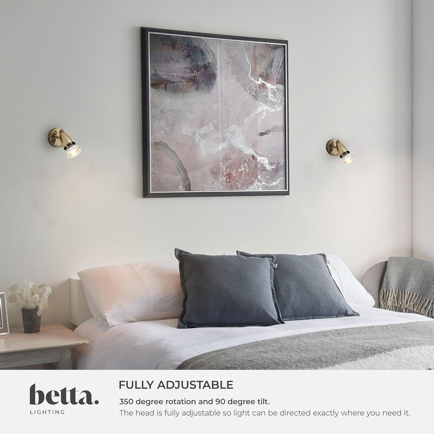 Modern bedroom with a bed, abstract art, and wall lights, featuring the brand 'betta'.
