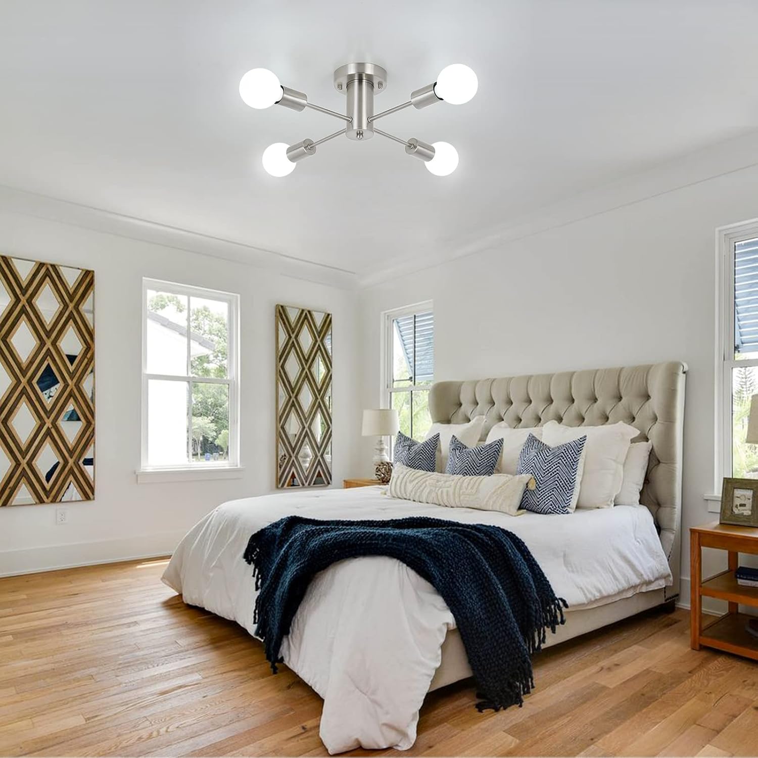Modern bedroom with a bed, lamp, and decorative pillows.