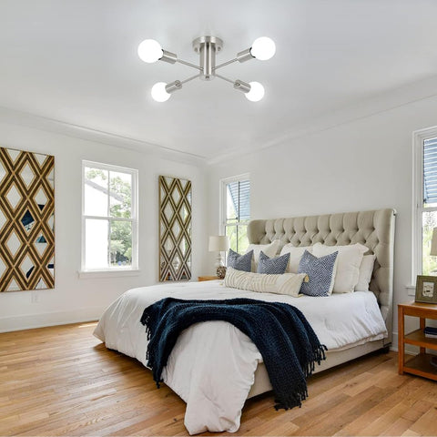 Modern bedroom with a bed, lamp, and decorative pillows.