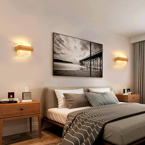 Modern bedroom with a bed, nightstands, and wall art depicting a beach scene.