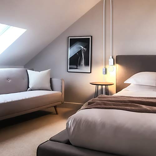 Modern bedroom with a bed, sofa, and wall art.