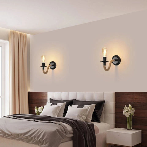 Modern bedroom with a bed, wall sconces, and decorative elements.