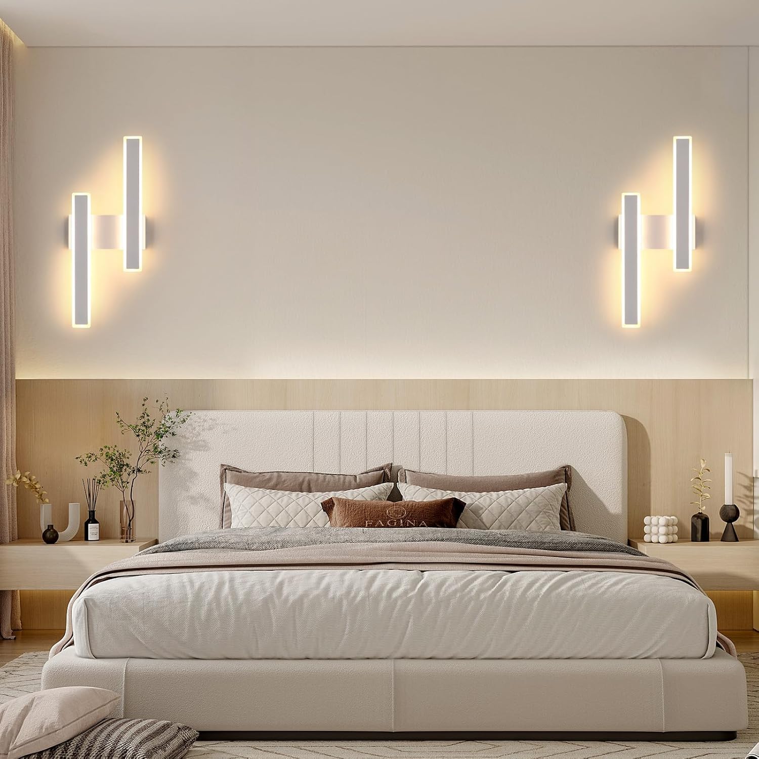Modern bedroom with a beige bed, wall sconces, and decorative items.