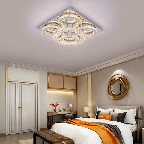 Modern bedroom with a crystal ceiling light fixture.