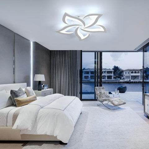 Modern bedroom with a decorative ceiling light fixture.
