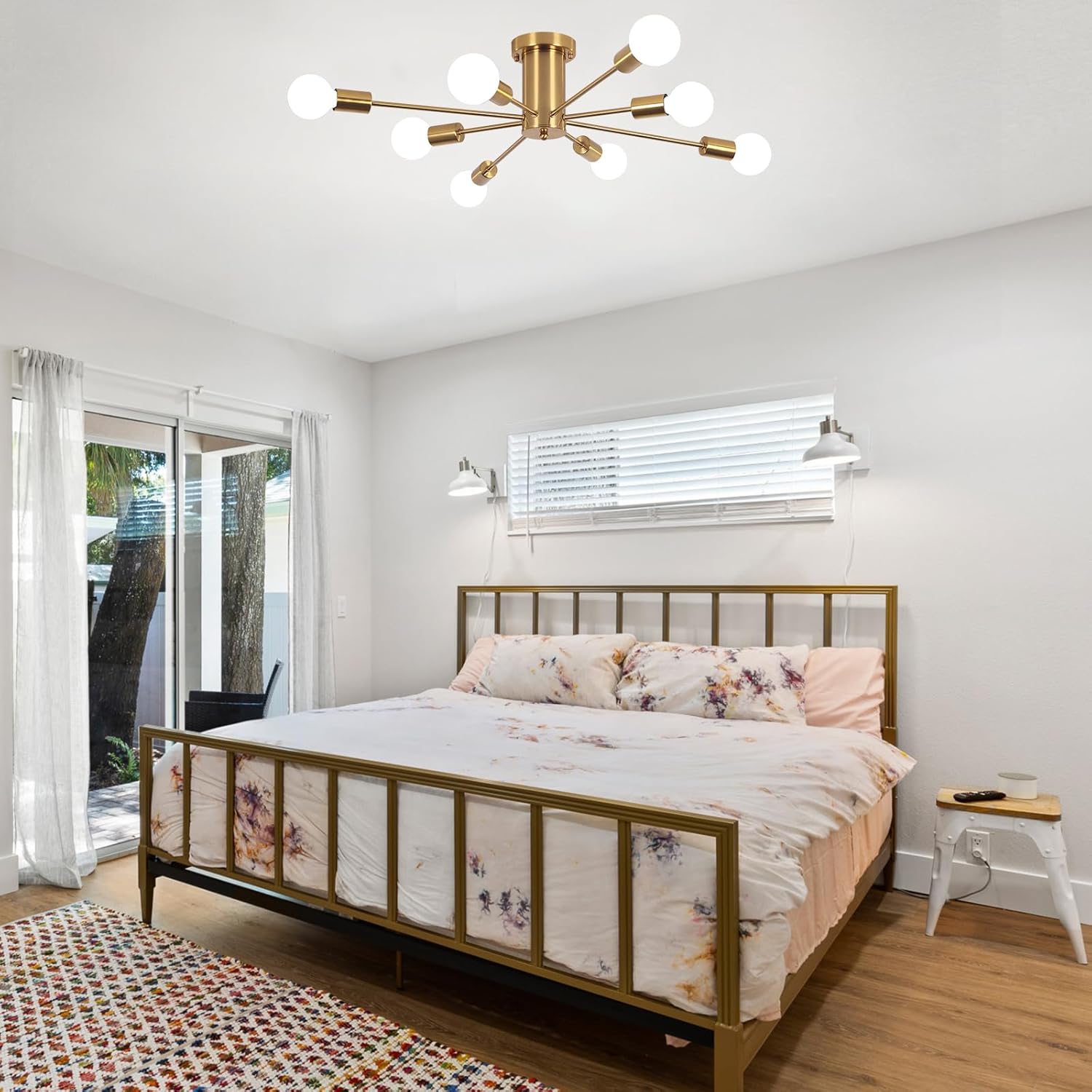 Modern bedroom with a gold bed frame and ceiling light fixture.