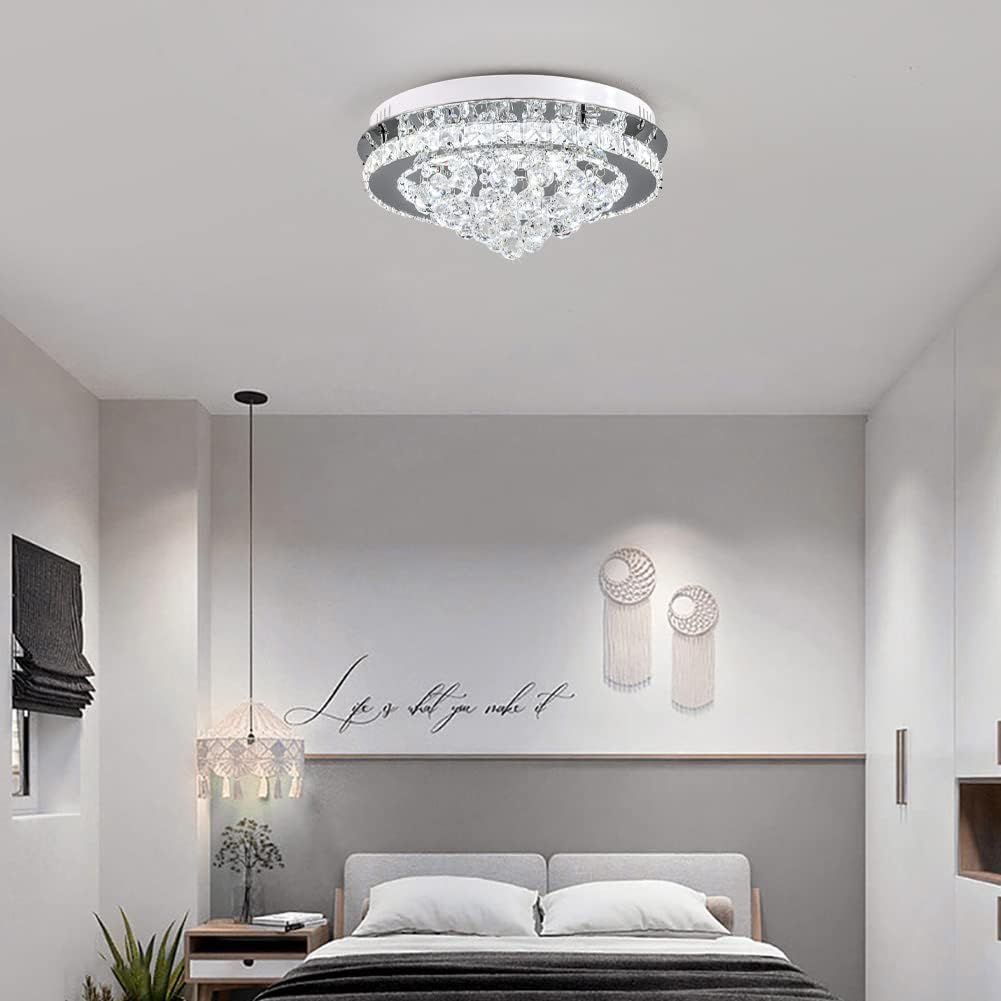 Modern bedroom with a crystal ceiling light fixture.