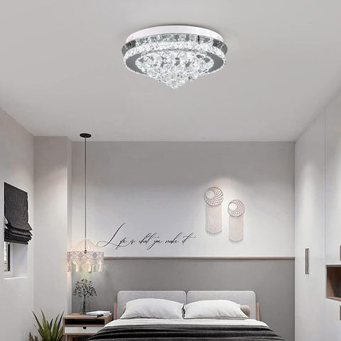 Modern bedroom with a crystal ceiling light fixture.