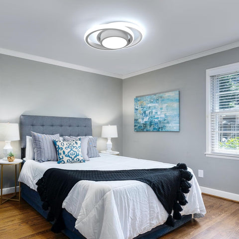 Modern bedroom with gray walls, a bed with white bedding and black blanket, and a ceiling light fixture.
