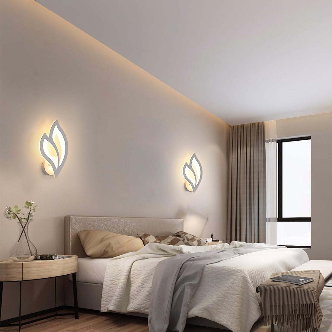 Modern bedroom with leaf-shaped wall lights, bed, and side table.