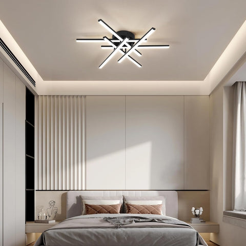Modern bedroom with a ceiling light fixture and neatly made bed.