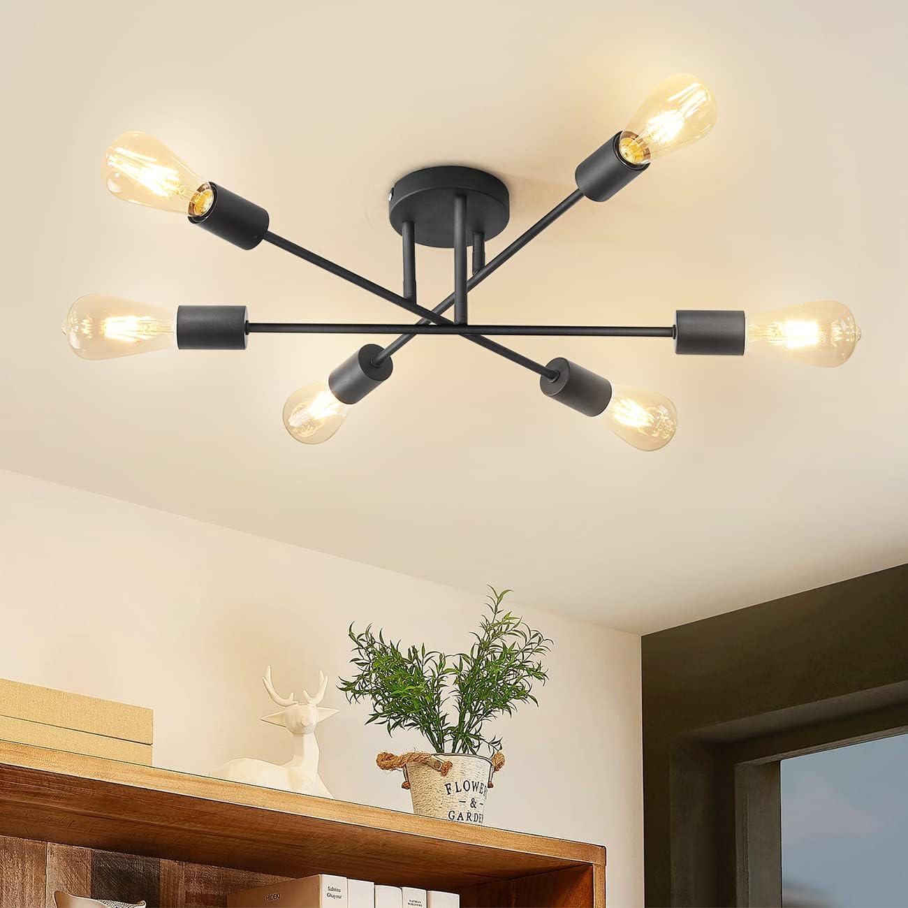 Modern black chandelier with multiple light bulbs in a room setting.