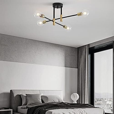 Modern ceiling light fixture in a bedroom setting with a bed and window in the background.