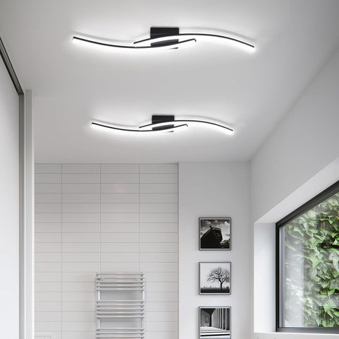 Modern ceiling light fixture in a room with white walls and a window.