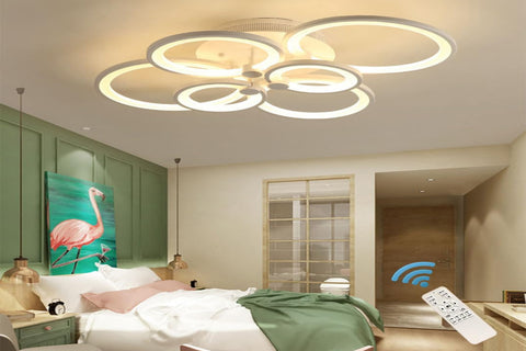 Modern ceiling light fixture in a bedroom setting with remote control