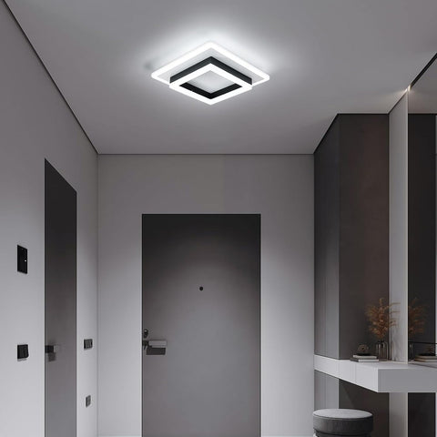 Modern ceiling light fixture in a minimalistic room with gray walls and a white ceiling.