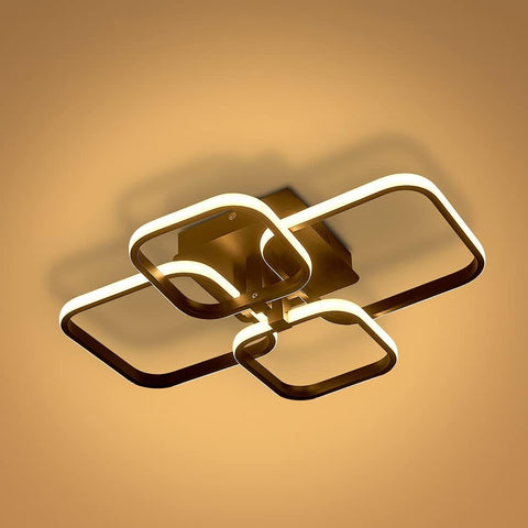 Modern ceiling light fixture with a warm glow on a beige background