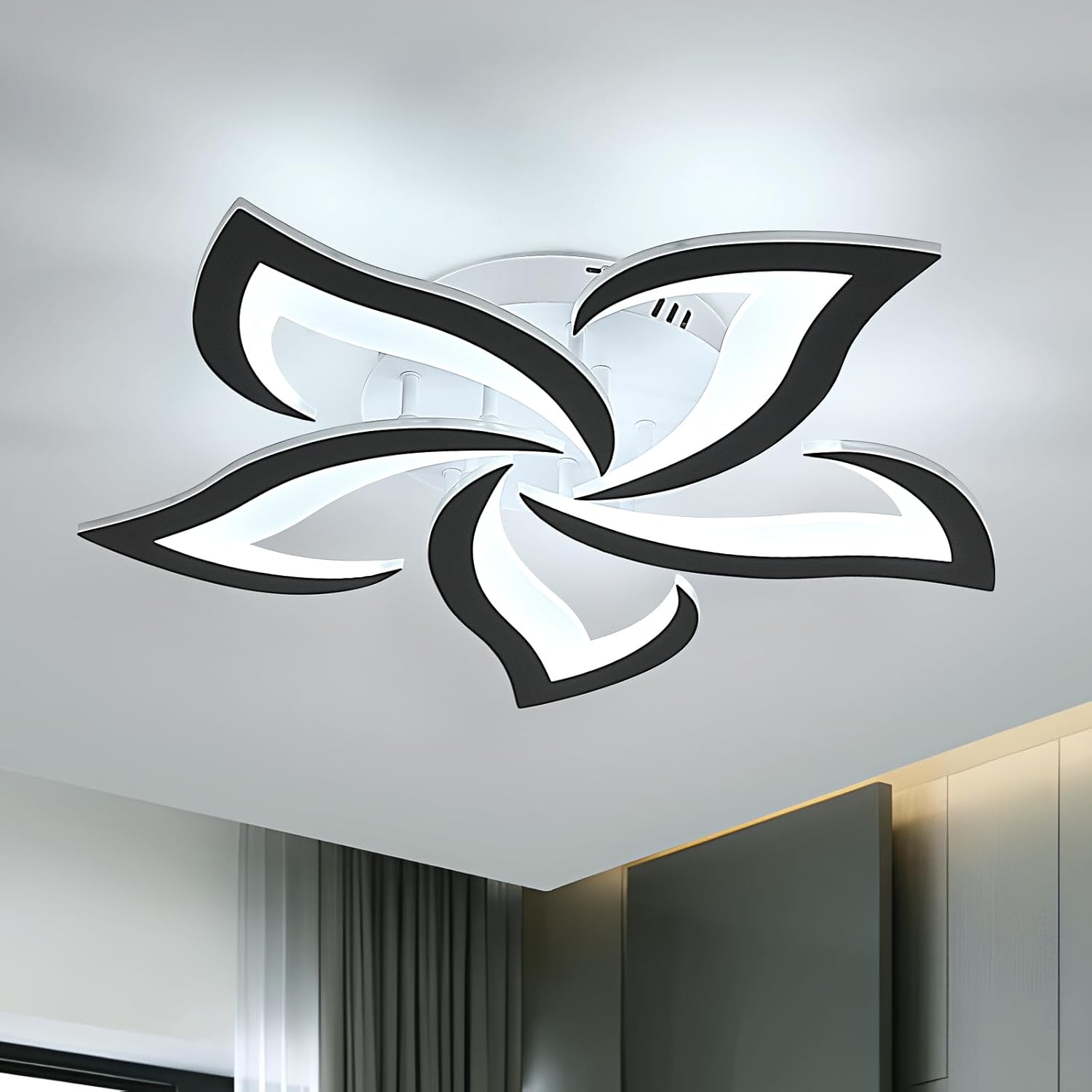 Modern ceiling light fixture with black and white design on a ceiling