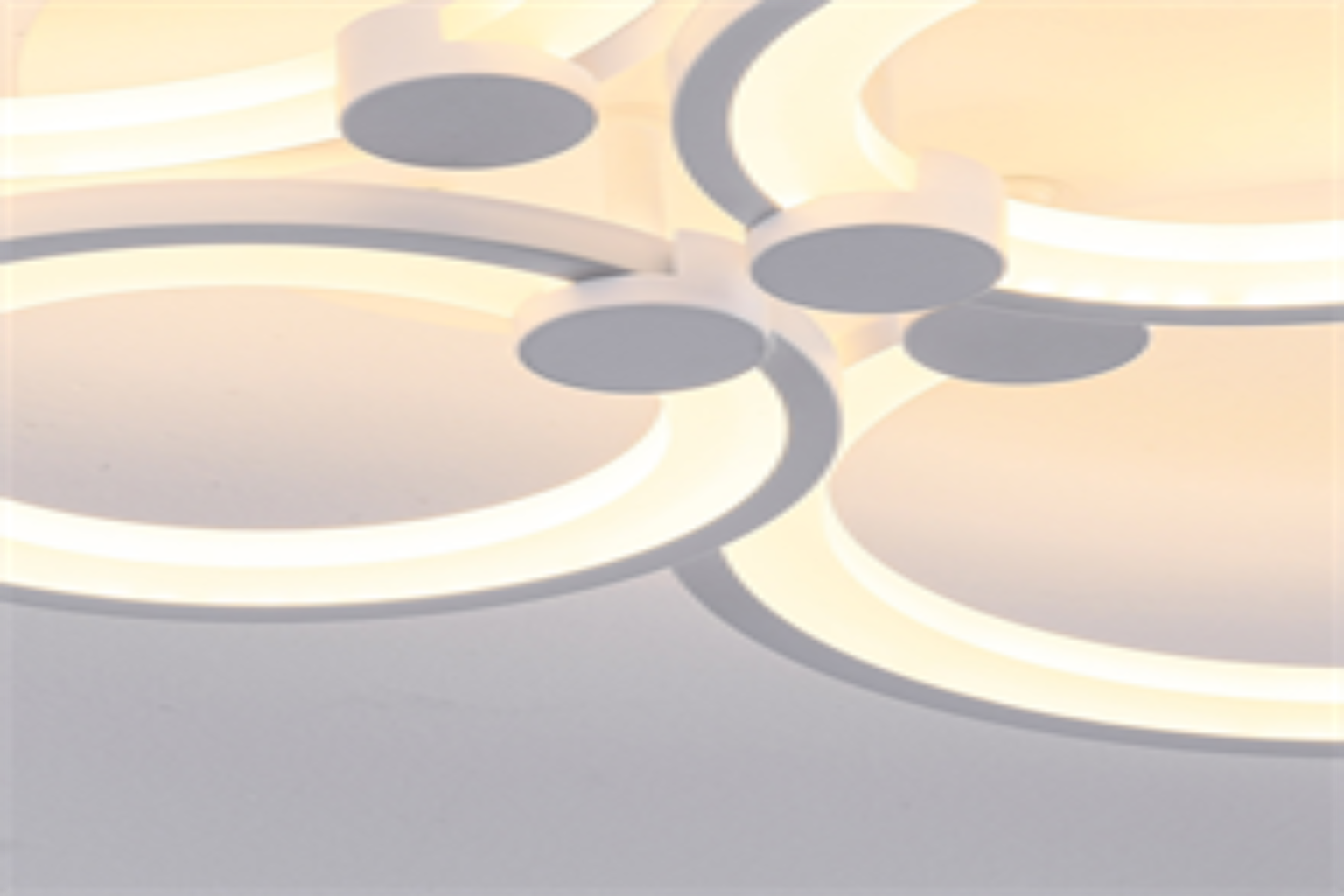 Modern ceiling light fixture with circular design on a neutral background