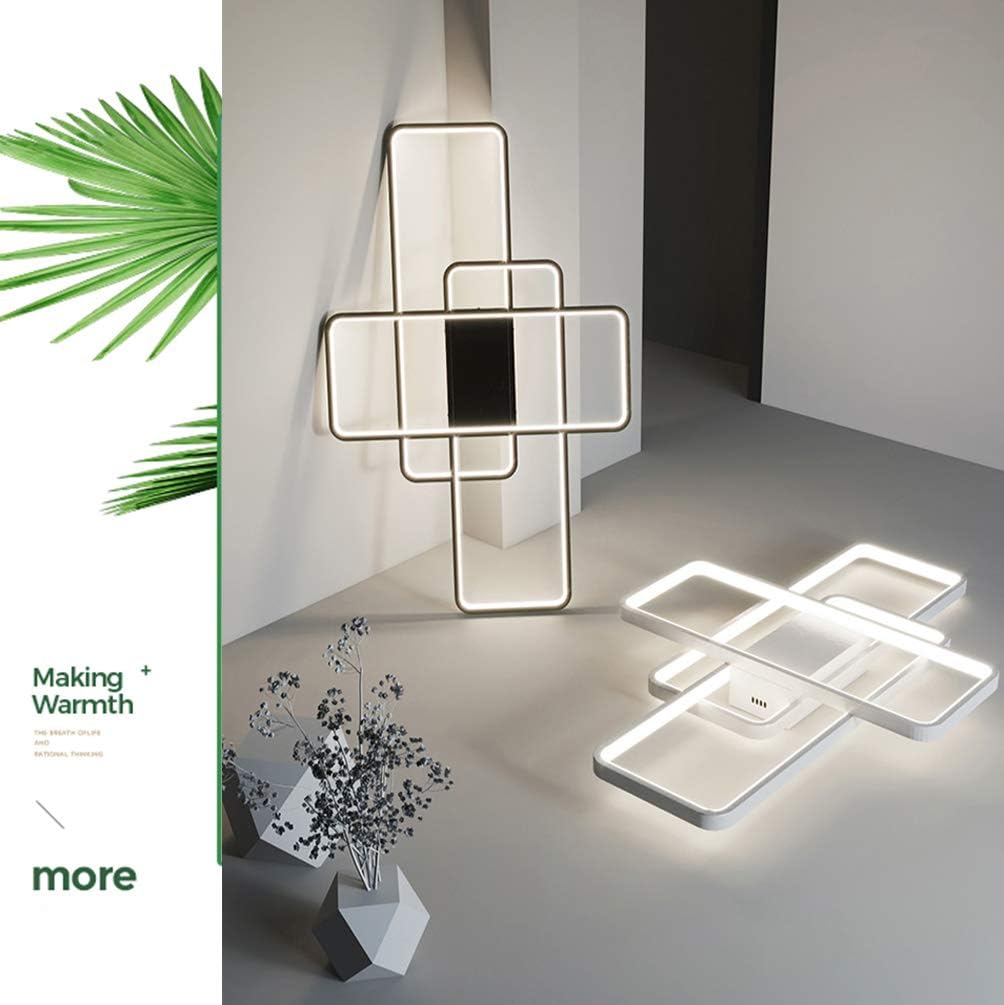 Modern ceiling light fixture with geometric design in a minimalistic setting.