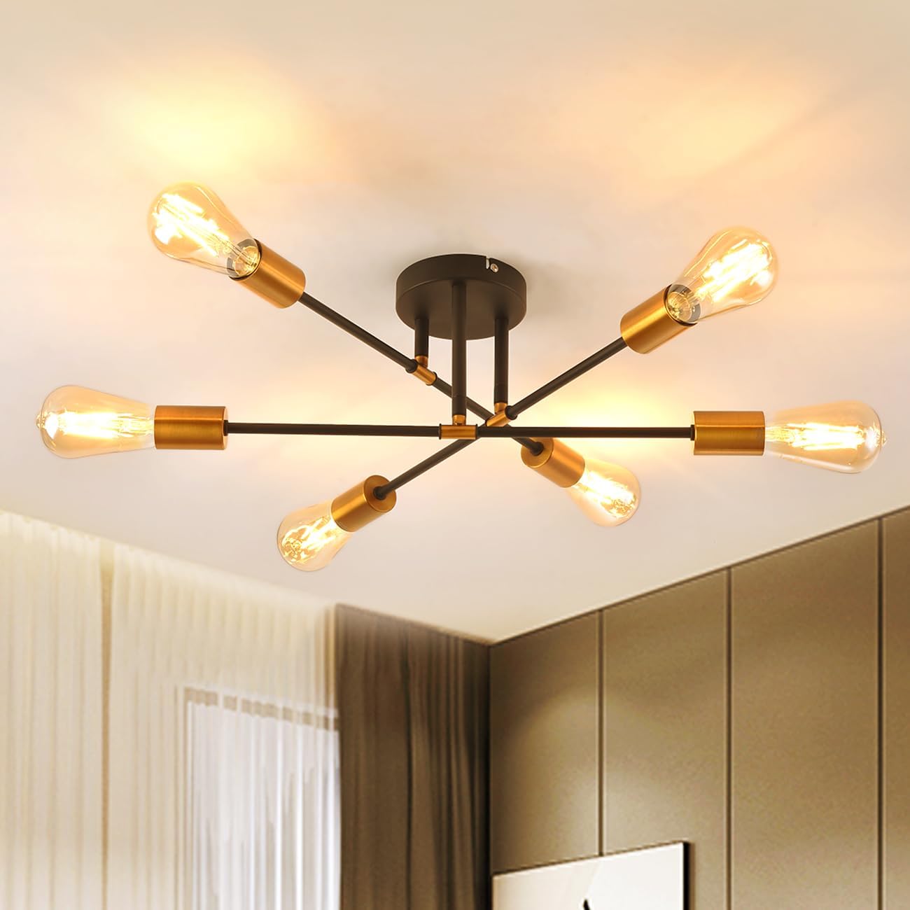 Modern ceiling light fixture with gold and black design in a room.
