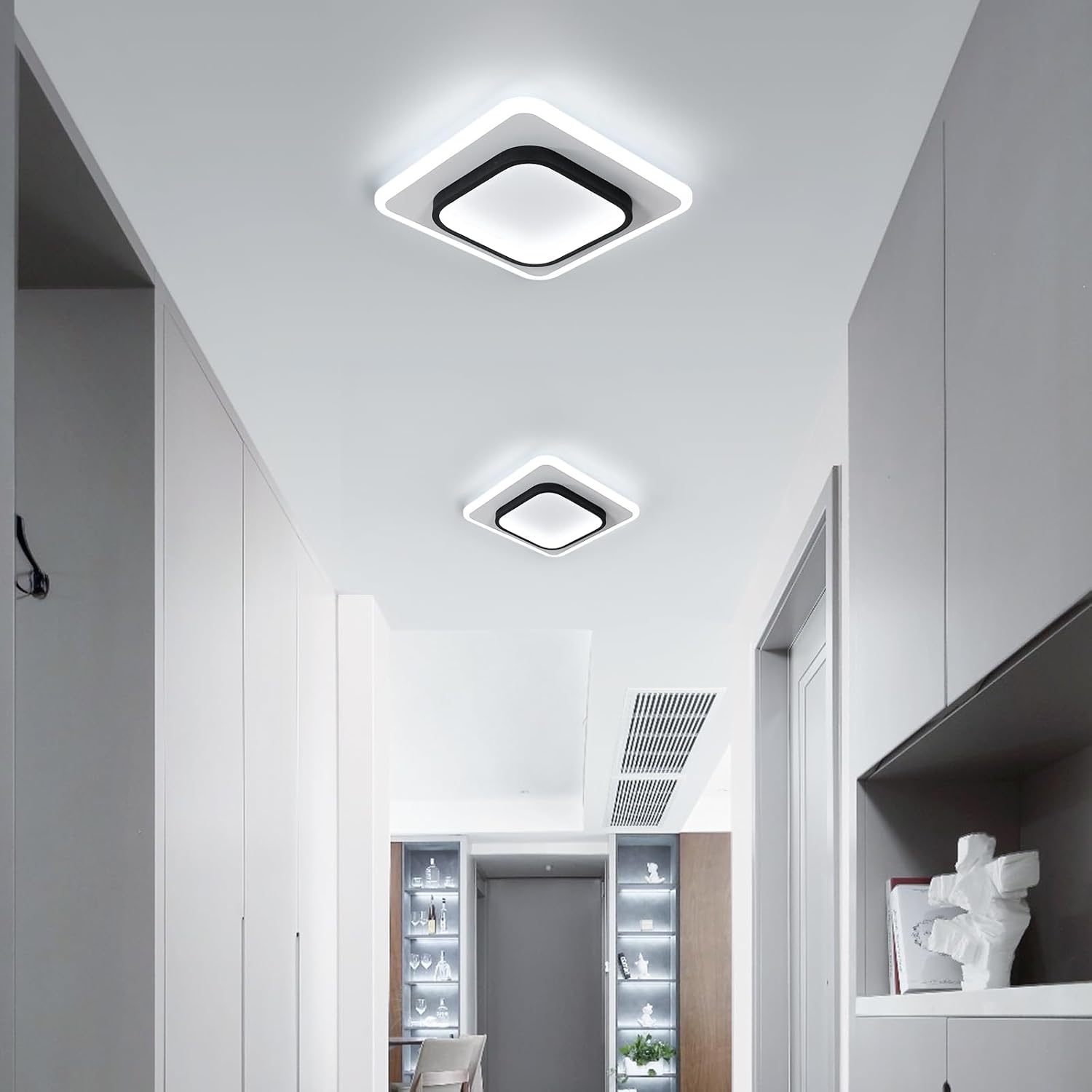 Modern ceiling lights in a well-lit room with white walls and a ceiling.