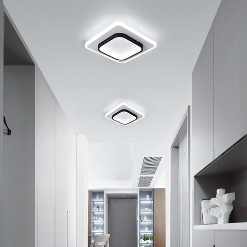 Modern ceiling lights in a well-lit room with white walls and a ceiling.