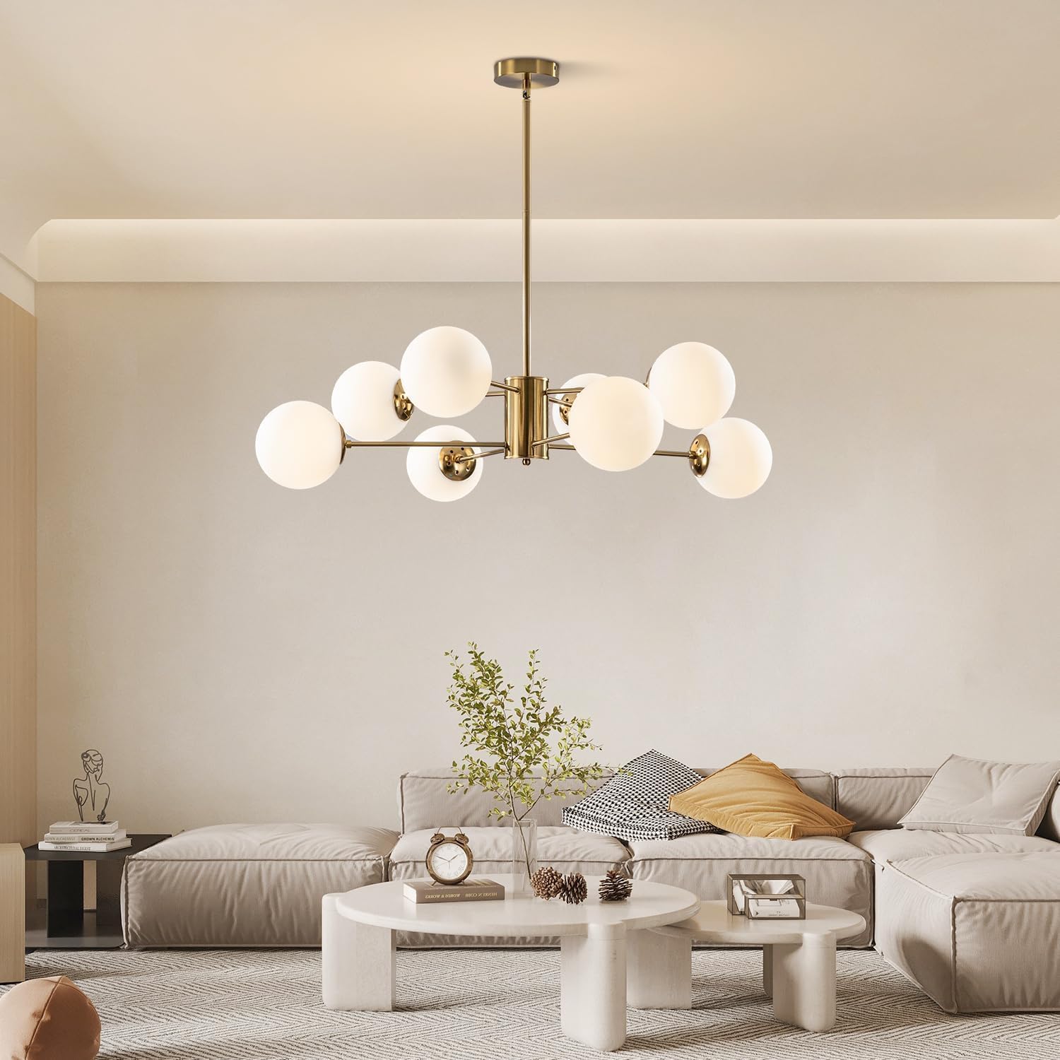 Modern chandelier hanging in a living room with a sofa and coffee table.