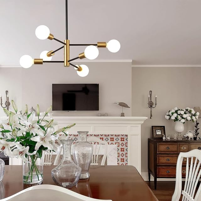 Modern chandelier in a living room with a fireplace and decorative items.