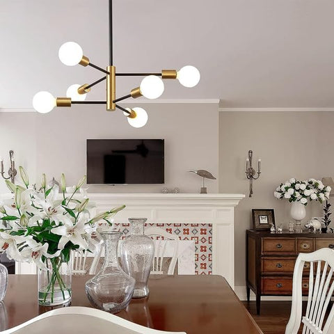 Modern chandelier in a living room with a fireplace and decorative items.
