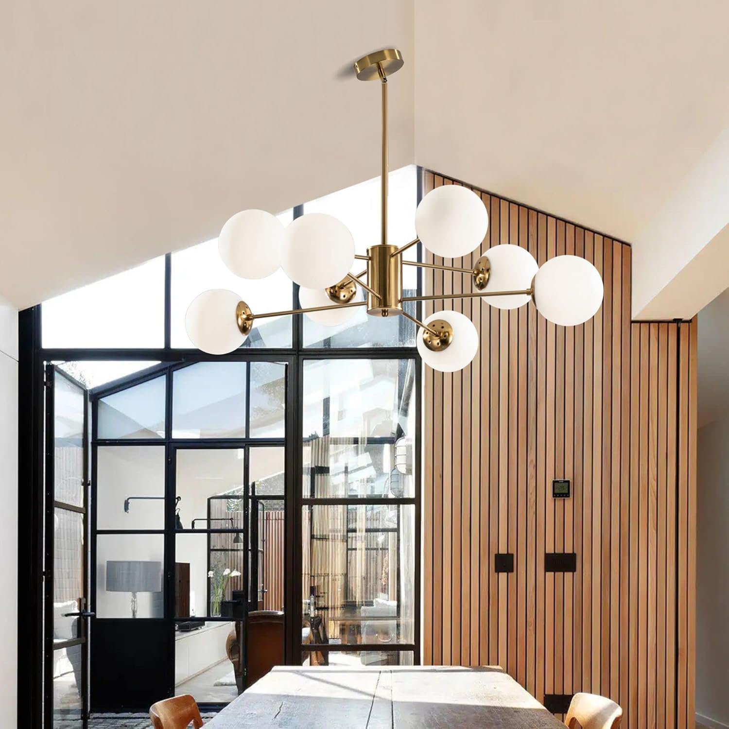Modern chandelier in a stylish interior setting with glass walls and wooden paneling.