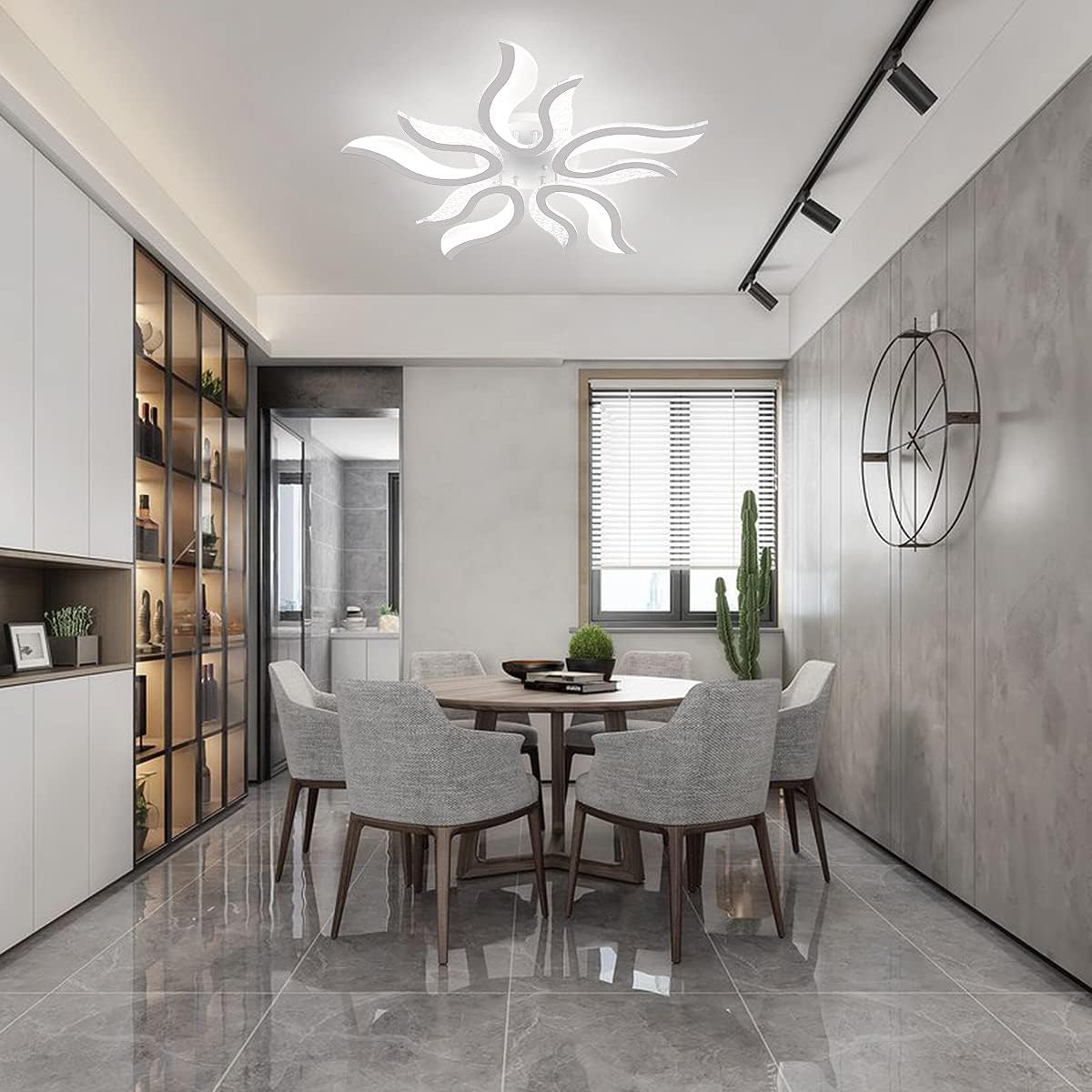 Modern dining room with a round table and chairs, ceiling light fixture, and wall clock.