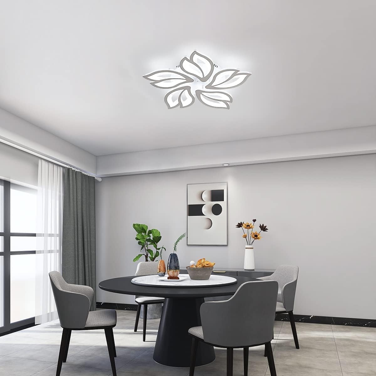 Modern dining room with a round table and chairs, decorative wall art, and ceiling light fixture.