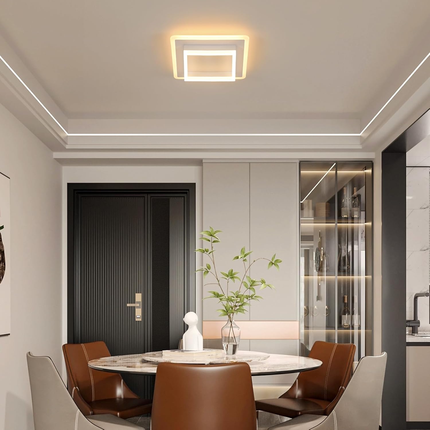 Modern dining room with round table, chairs, and decorative elements.