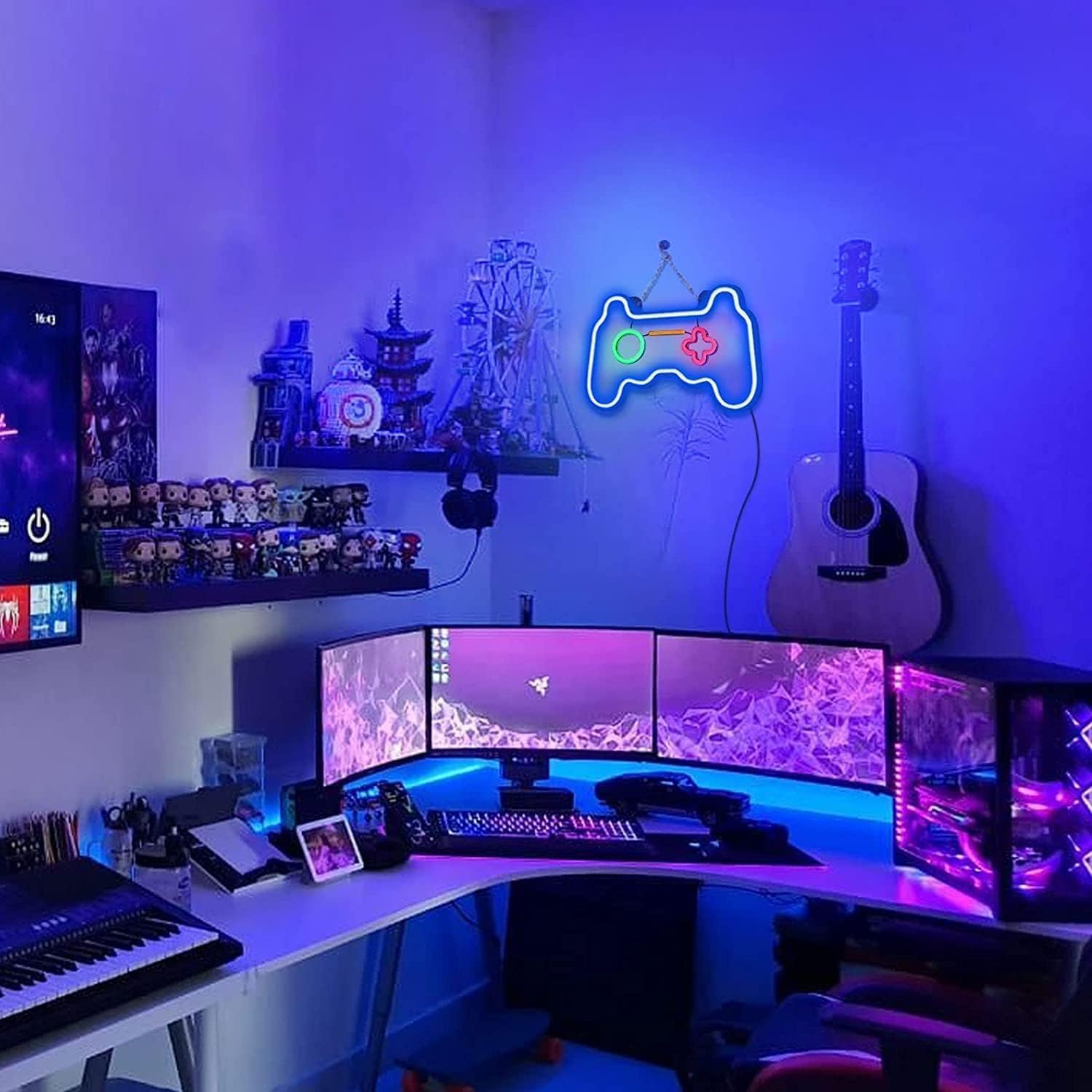 Modern gaming setup with multiple monitors, gaming accessories, and a neon light on a wall.