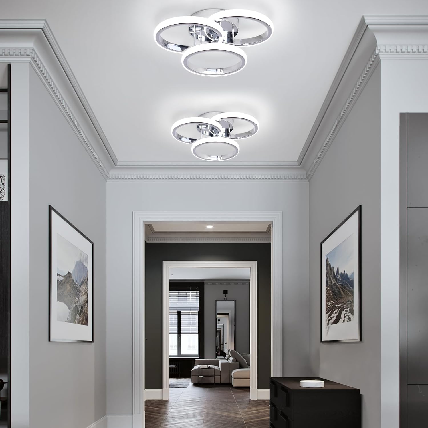 Modern hallway with ceiling lights and framed pictures on a gray wall.