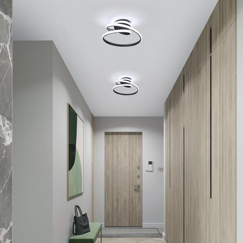 Modern hallway with ceiling lights, door, and wall art