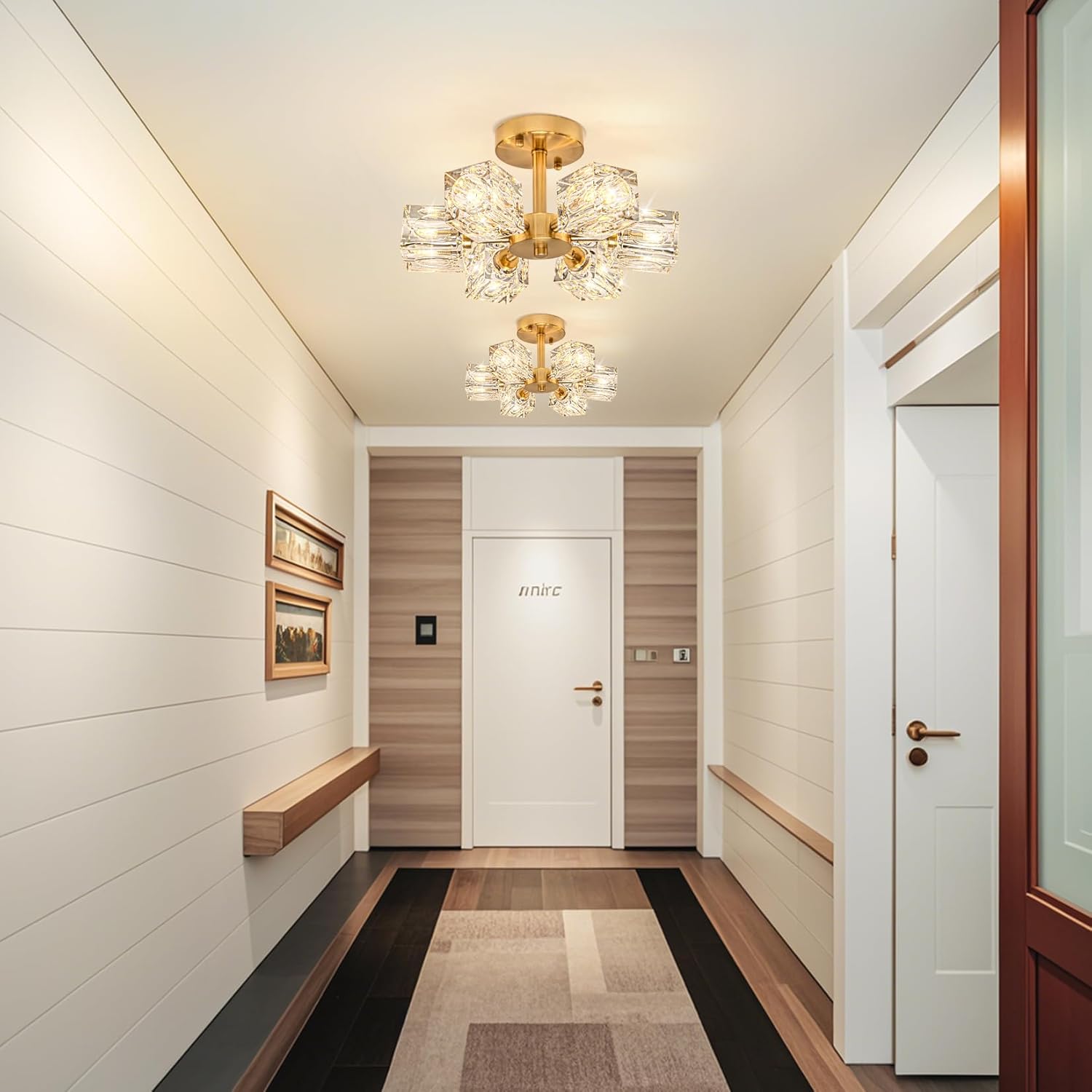 Modern hallway with decorative ceiling lights, white walls, and a door.