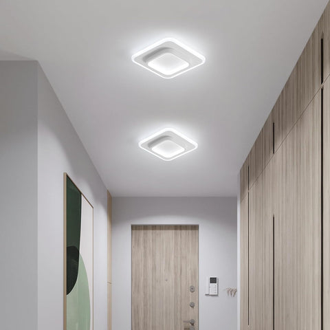 Modern hallway with square ceiling lights, wooden door, and wall-mounted phone.