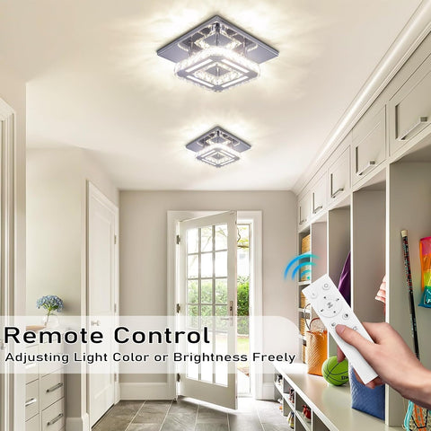 Modern home interior with ceiling lights and a hand holding a remote control.