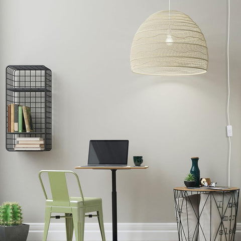 Modern home office with a desk, chair, lamp, and decorative items.