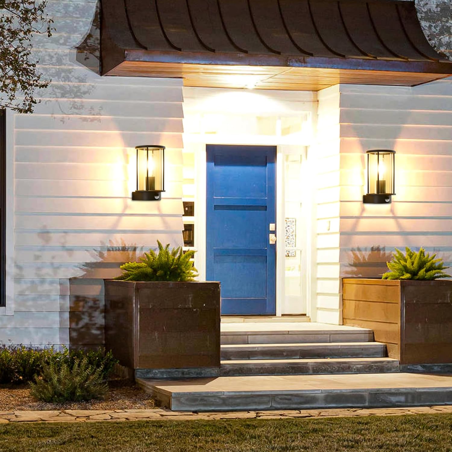 Modern house entrance with a blue door, steps, and outdoor lighting fixtures.