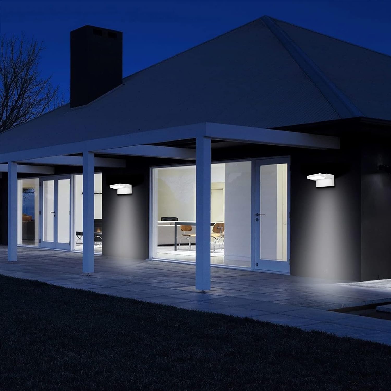 Modern house exterior at night with illuminated interior