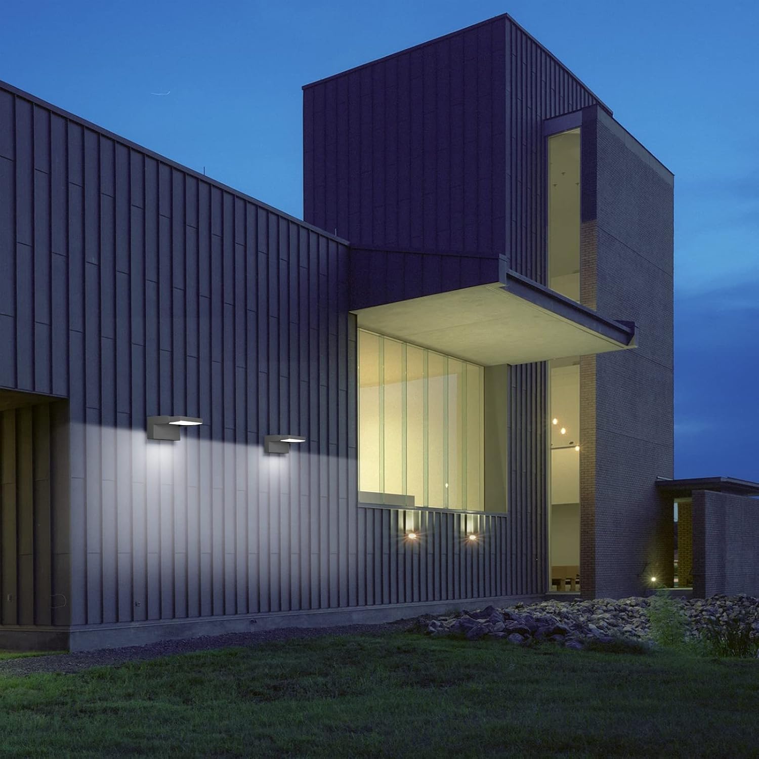 Modern house exterior at night with illuminated windows