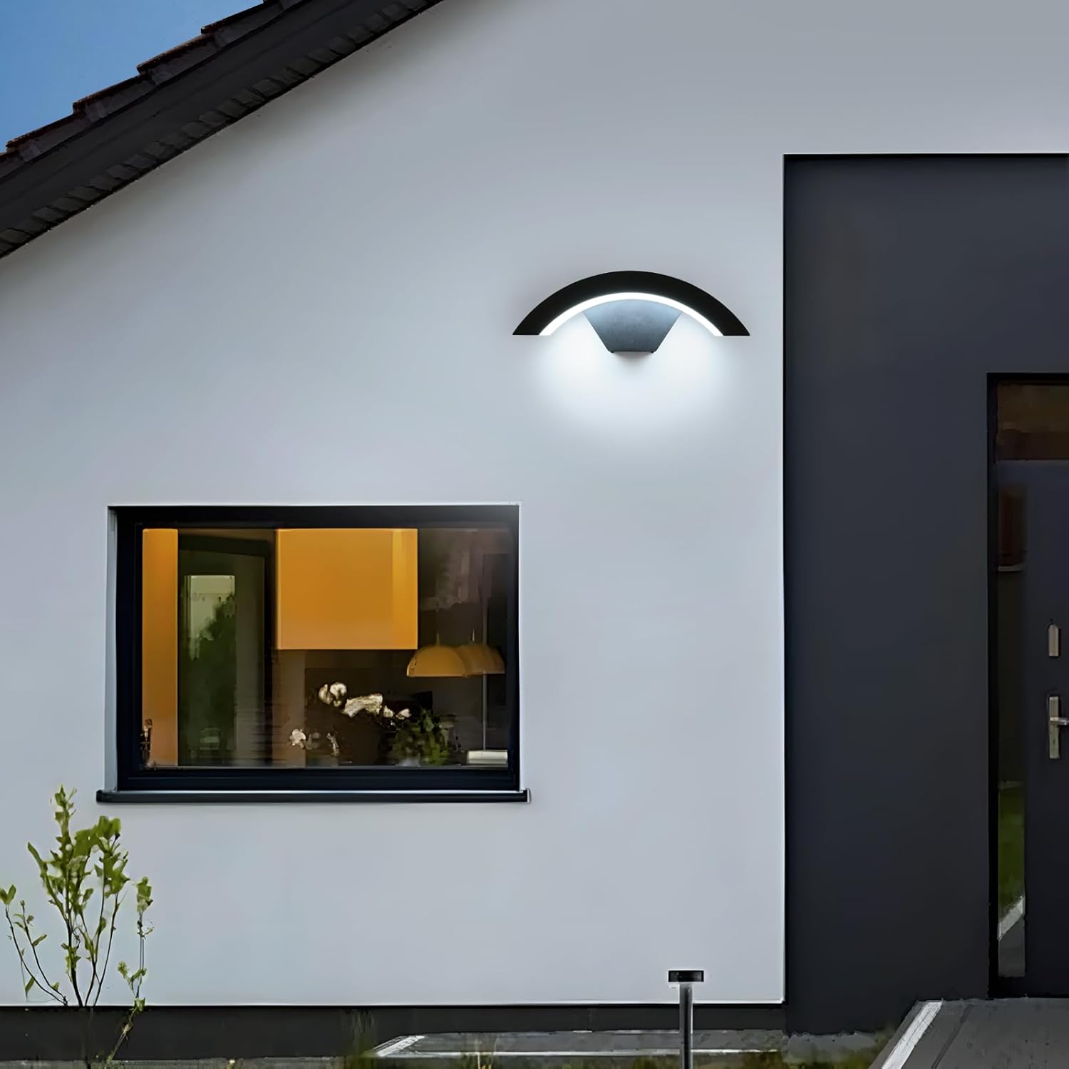 Modern house exterior with a wall-mounted light fixture and window.