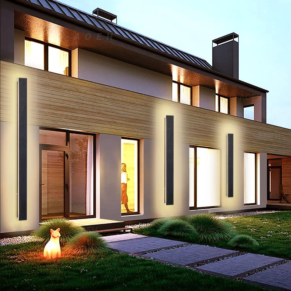 Modern house exterior with illuminated windows and a decorative fox figure on a stone path.